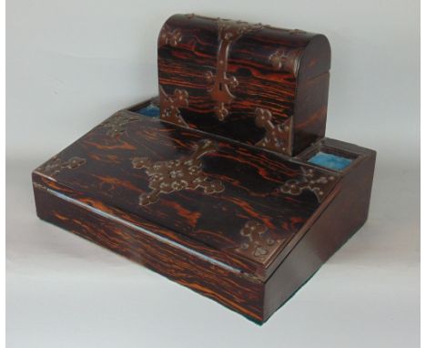 A good coromandel and brass strap work desk box, mounted by a domed trunk with segmented interior, over a folding baize lined