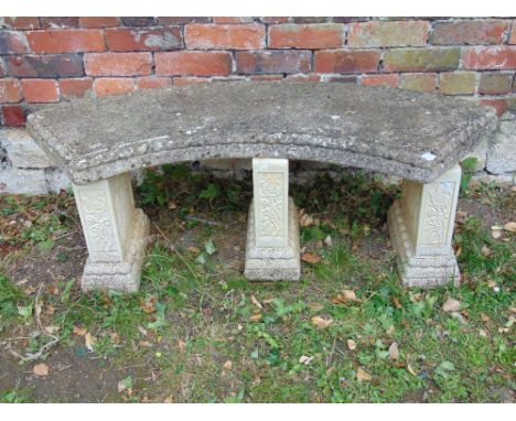A contemporary cast composition stone garden bench, the crescent shaped slab seat with rope twist border raised on three pede