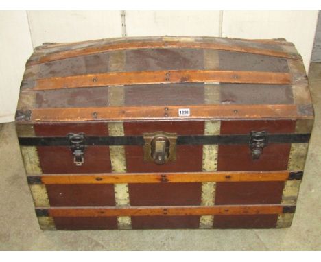 A late 19th century canvas and lathe bound travel trunk with domed lid