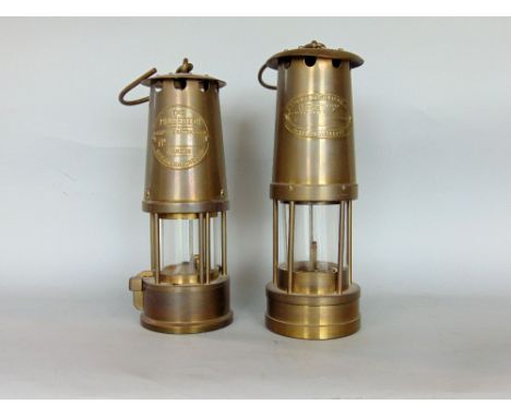 Two vintage brass miners lamps, one inscribed The Protector, Eccles Manchester, the other E Thomas and Williams Ltd (2)