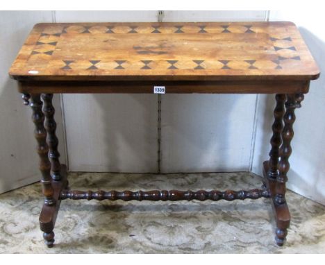 A Victorian walnut occasional table, the rectangular top with repeating geometric inlaid detail raised on bobbin supports, an