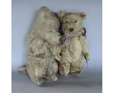 A vintage teddy bear with brown fur, stitched nose, mouth and claws, velveteen paws and articulated limbs, together with a py