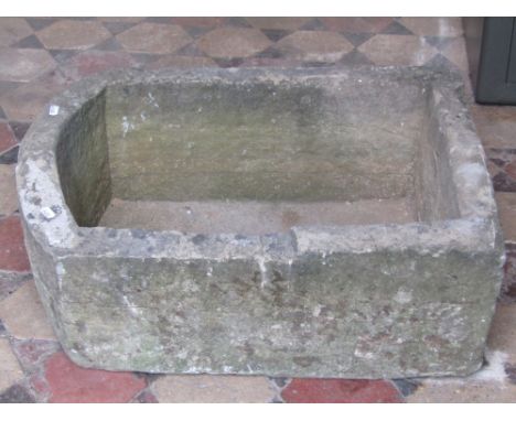 A weathered natural stone trough of rectangular form with single D end, 64 cm long x 45 cm wide x 26 cm height