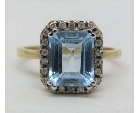 9ct ring set with blue topaz within diamond surround, size P, 5g