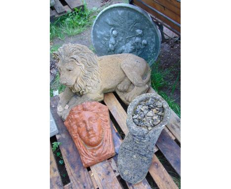 A composition stone garden ornament in the form of a recumbent lion together with an Art Nouveau style wall pocket, circular 