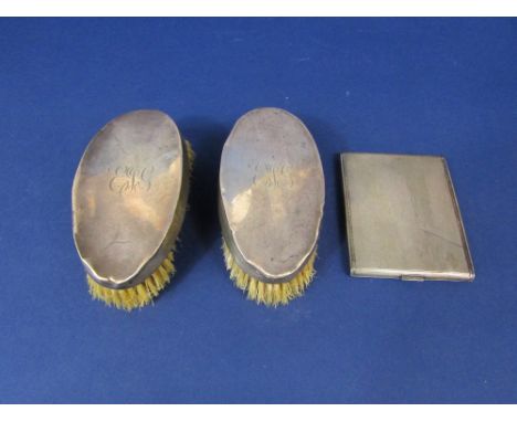 Engine turned silver cigarette case with gilt interior, 4.5oz approx; together with two silver topped brushes (3)