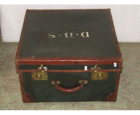 A good Edwardian travelling trunk, the green panels within mid tan coloured leather borders with heavy gauge brass fittings, 