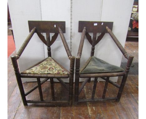 A pair of antique oak turners chairs of usual form with turned bobbin mouldings, triangular seats and simple splat backs