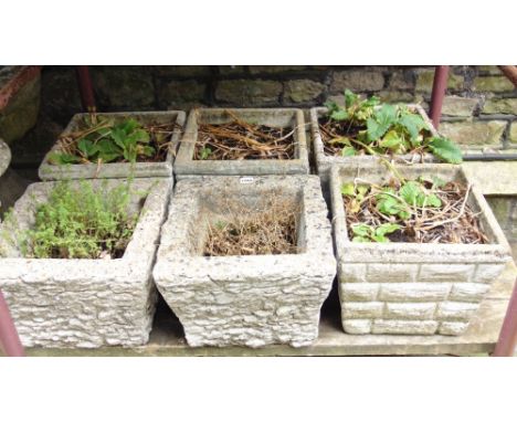 Six similar composition stone planters of square and slightly tapered form with simulated stone wall facade together with a g