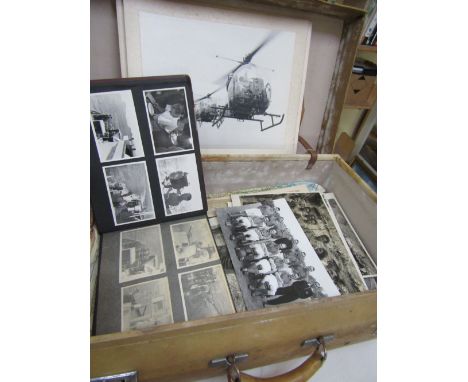 A suitcase containing an interesting collection of mainly military related ephemera to include a mid 20th century black and w