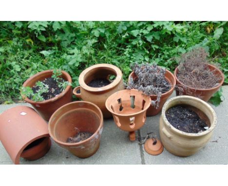 A small collection of contemporary outsized terracotta flower pots, strawberry planter, etc