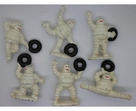 Six cast iron posing Michelin Man figurines, tallest H: 7 cm. P&amp;P Group 1 (£14+VAT for the first lot and £1+VAT for subse