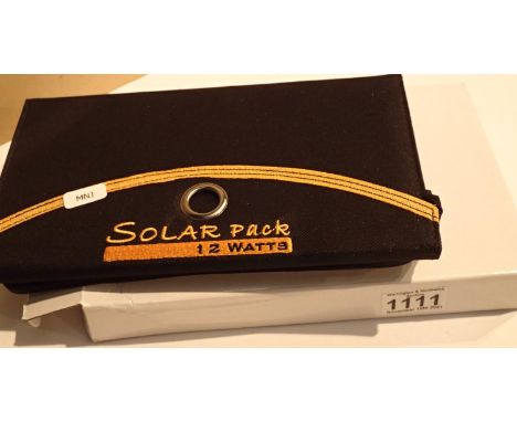 New old stock, 12 watt folding solar panel pack with two USB charging outputs. Integral part of case with magnetic catch and 
