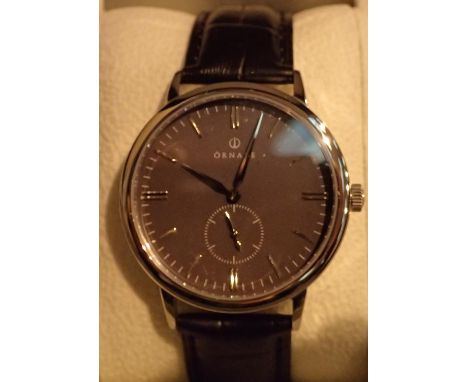 New old stock Ornake silver and black boxed gents wristwatch, with second hand and leather strap. P&amp;P Group 1 (£14+VAT fo