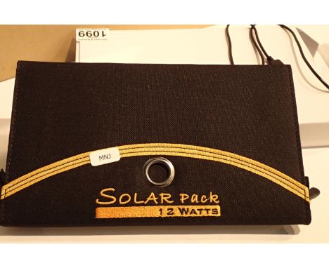 New old stock, 12 watt folding solar panel pack with two USB charging outputs. Integral part of case with magnetic catch and 