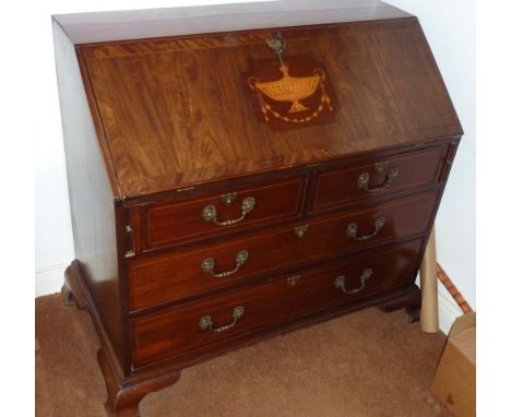 A late 18th Century mahogany Writing Bureau, the sloping fall with a central Adamesque style marquetry urn and harebells, fur