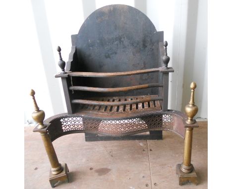 A large and heavy cast iron and brass Fire Grate in late 18th Century style, the pierced serpentine steel front flanked by tw