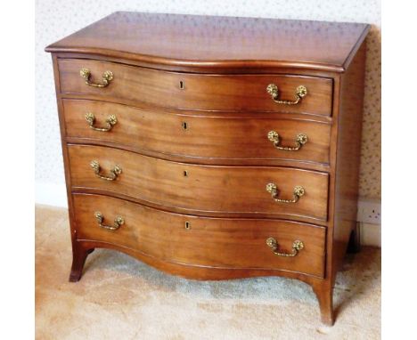 A late 18th Century serpentine fronted mahogany Commode, moulded top above four full width graduated drawers with cast gilt m