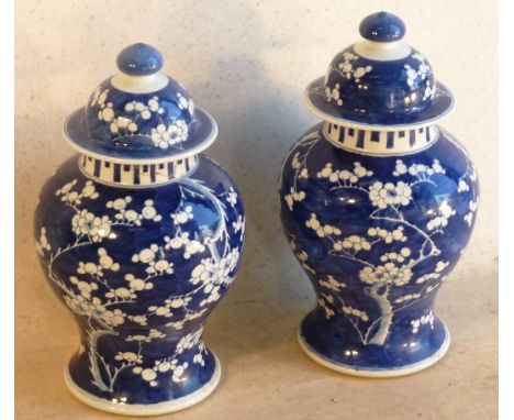 A pair of Kangxi style (19th Century) large porcelain baluster shaped Vases and Covers, hand decorated in typical style with 