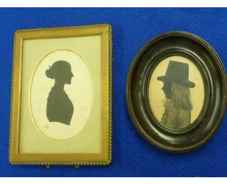 A 19th Century oval ebonised Portrait Silhouette of a young boy in top hat together with one other larger brass framed exampl