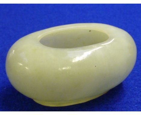 A Chinese oval Nephrite jade Water Pot on conforming oval foot, the celadon stone of cloudy form 7cm wide 