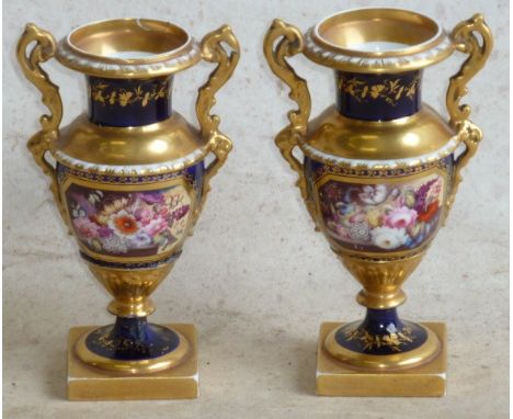A pair of early 19th Century two handled hard paste porcelain Vases, each gilded and with a finely painted floral spray vigne