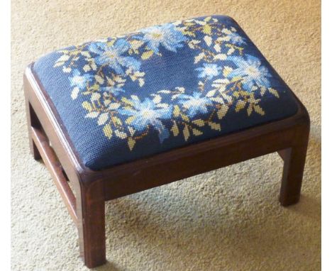 A small George III period mahogany Stool having drop in needlework seat and square moulded legs united by an 'H' form stretch