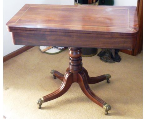 An early 19th Century mahogany and brass inlaid fold over top Card Table with turned stem, four downswept moulded legs termin