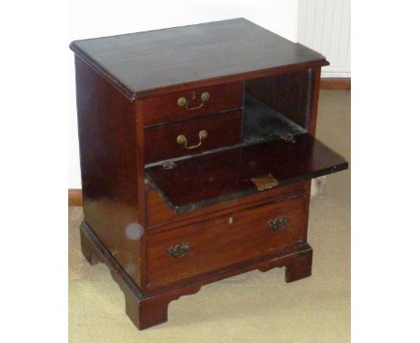 An unusual 19th Century mahogany Chest, the moulded top above a double false drawer front dropping to reveal two small left h