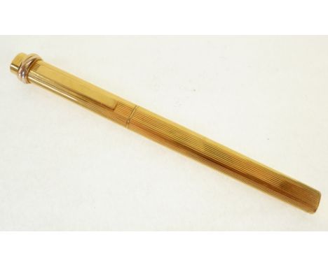 CARTIER, PARIS, GOLD PLATED BALL POINT PEN, engine turned with bi-coloured gold trinity ring top, 180504