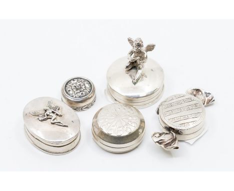 A collection of 925 stamped silver pill boxes to include: sweet shaped; oval with fairy applied to cover, another with puttin