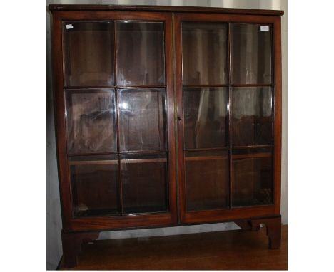 An early 19th Century mahogany bookcase top, raised on later bracket feet (likely to have originally been the upper section o