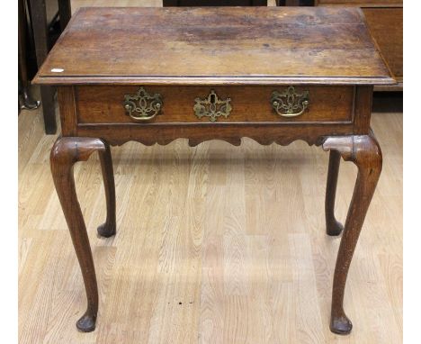 A mid 18th Century oak side table, fitted with a single drawer fitted with brass handles and an escutcheon, raised on cabriol