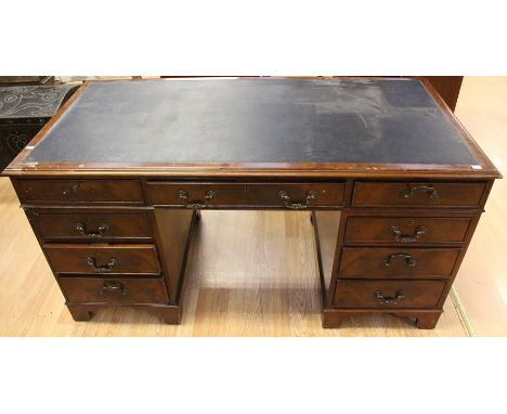 An Georgian style mahogany twin pedestal desk, early 20th Century, comprising long central drawer and eight small drawers, ra