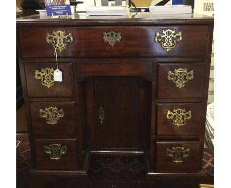 A George III and later mahogany kneehole desk, fitted with a single drawer to top, a secret frieze drawer below, with three s