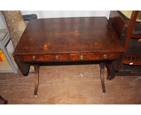 A Regency style walnut veneered sofa table, fitted with two drawers, measuring 69cm high, 95cm wide, 64cm deep