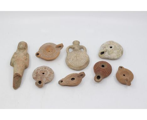 A collection of antiquities including an Egyptian deity, Roman oil lamp, perfume bottle etc