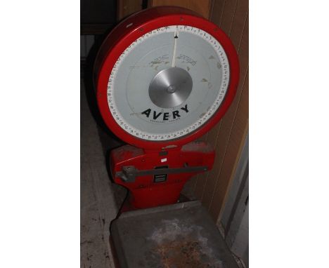 An Avery floor standing set of postage scales, 50kg max weight, in red, 116cm high, 65cm wide, 80cm deep