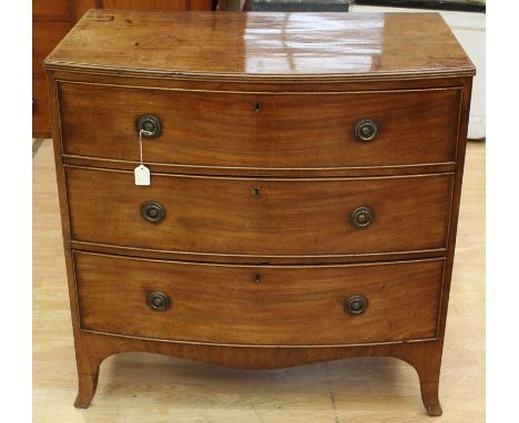 An early 19th Century mahogany chest of drawers, bow fronted form, comprising three drawers each fitted with locks, bracket f