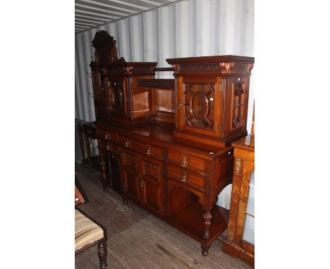 A late Victorian mirror backed sideboard, the upper section with two glazed doors, mirror to back centre, the base section wi