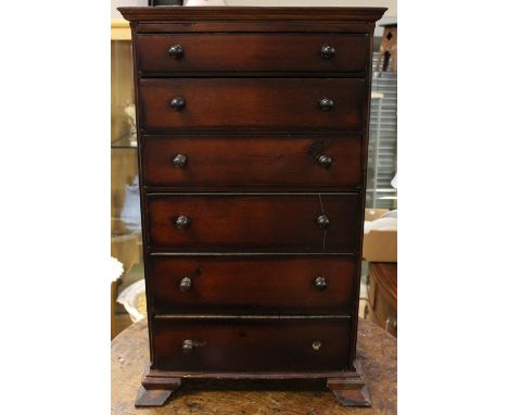 A Victorian miniature table top chest of drawers, possibly made as an apprentice piece, comprising six long drawers, raised o