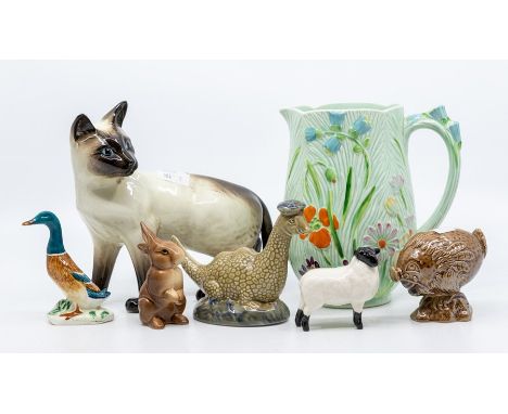 Collection of Beswick figures including Siamese cat, sheep, rabbit, duck, along with a water jug, two Beswick Scotch Whisky c