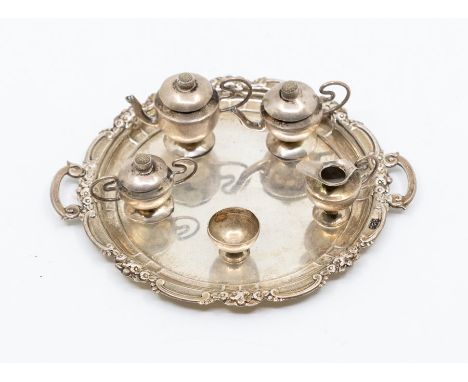 A 925 sterling silver circular miniature two handled tray together with a miniature white metal tea service, tray approx 10.3