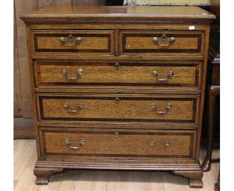 A George III oak and mahogany cross-banded chest of drawers, circa 1790, comprising two short over three long graduated drawe