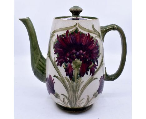 Moorcroft: A William Moorcroft 'Revived Cornflower' pattern coffee pot. Unusual mauve colourway. Burslem mark. Height approx 