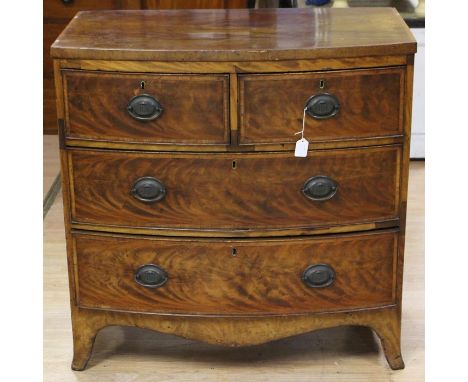 An early Victorian mahogany bow fronted chest of drawers, fitted with two short over two long drawers, raised on splayed brac