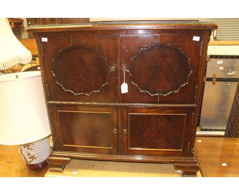 An early 20th Century mahogany drinks cabinet, two doors over two doors, ogee bracket feet, 77cm high, 80cm wide, 46cm deep