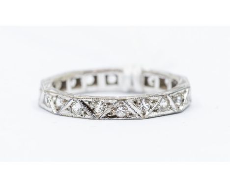 A mid century 9ct white gold eternity ring set with white stone possibly white quartz, each stone grain set in a triangular d