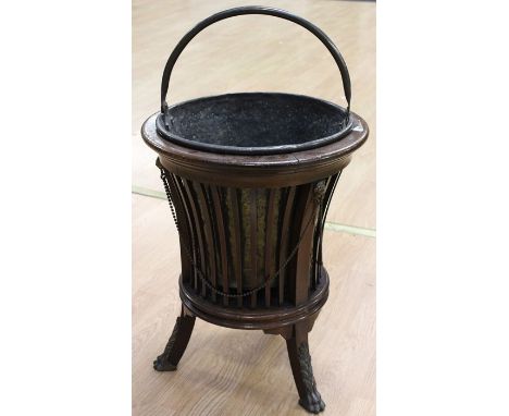 A 20th century mahogany wine cooler on three claw feet, with inner brass bucket, height approx. 63cm.