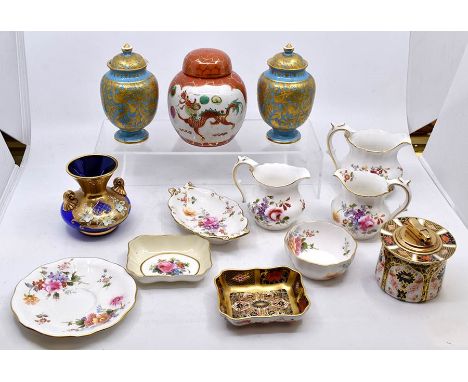 A collection of Royal Crown Derby, comprising a pair of blue ground vases and covers, a 1128 Imari pattern table lighter, a 1